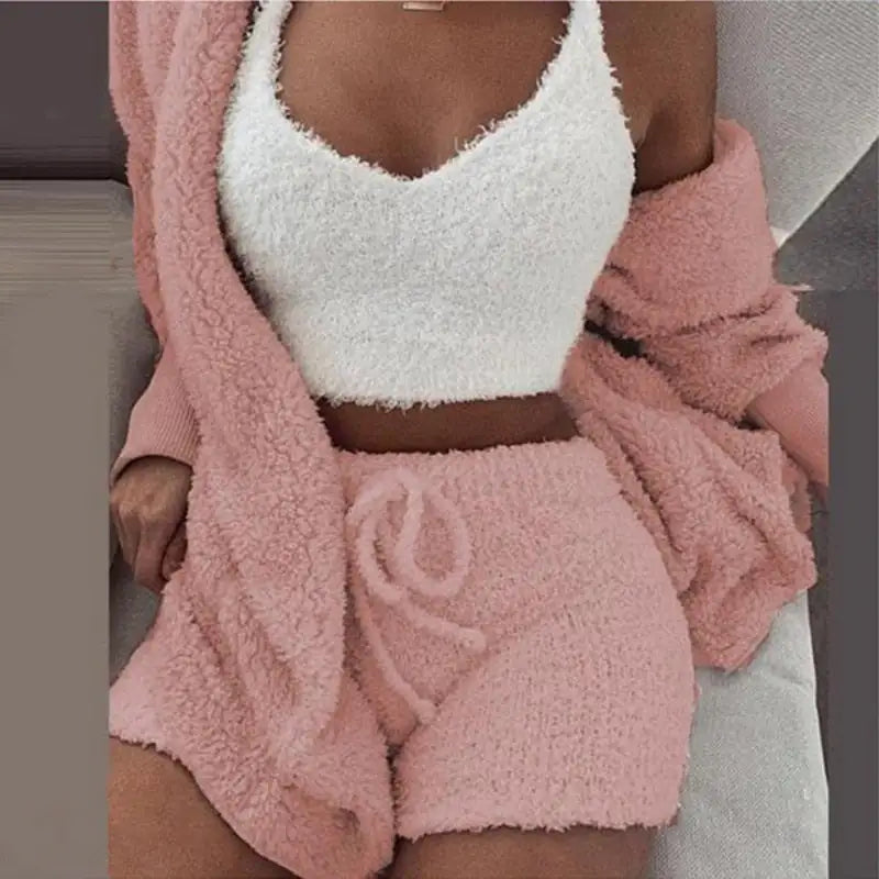 Stylish 3-piece knit set in pink, ideal gift for her. Features a fluffy tank top, matching shorts, and a soft cardigan.